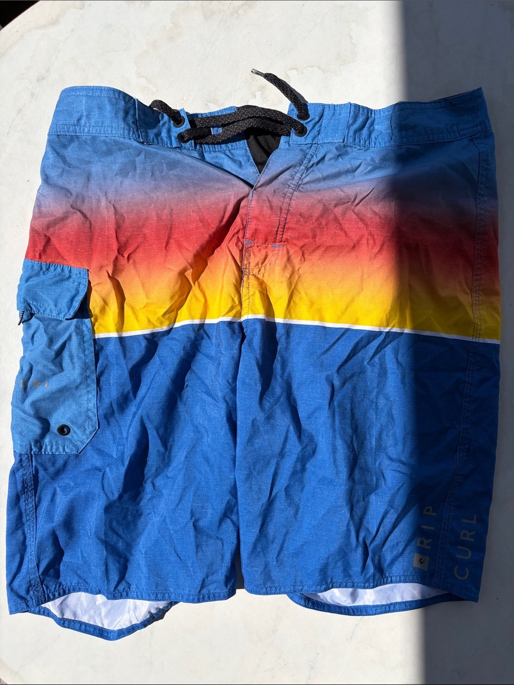 Rip Curl Men’s Blue Board Shorts with Red and Yellow Gradient
